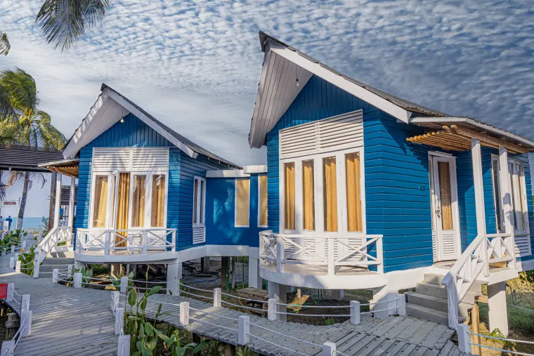 Beachfront villas beneath a blue island sky
