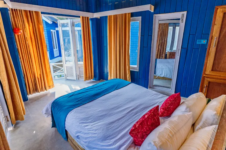 A bright bedroom washed in island light