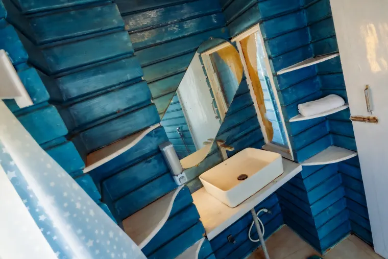 A spacious bathroom finished in blue