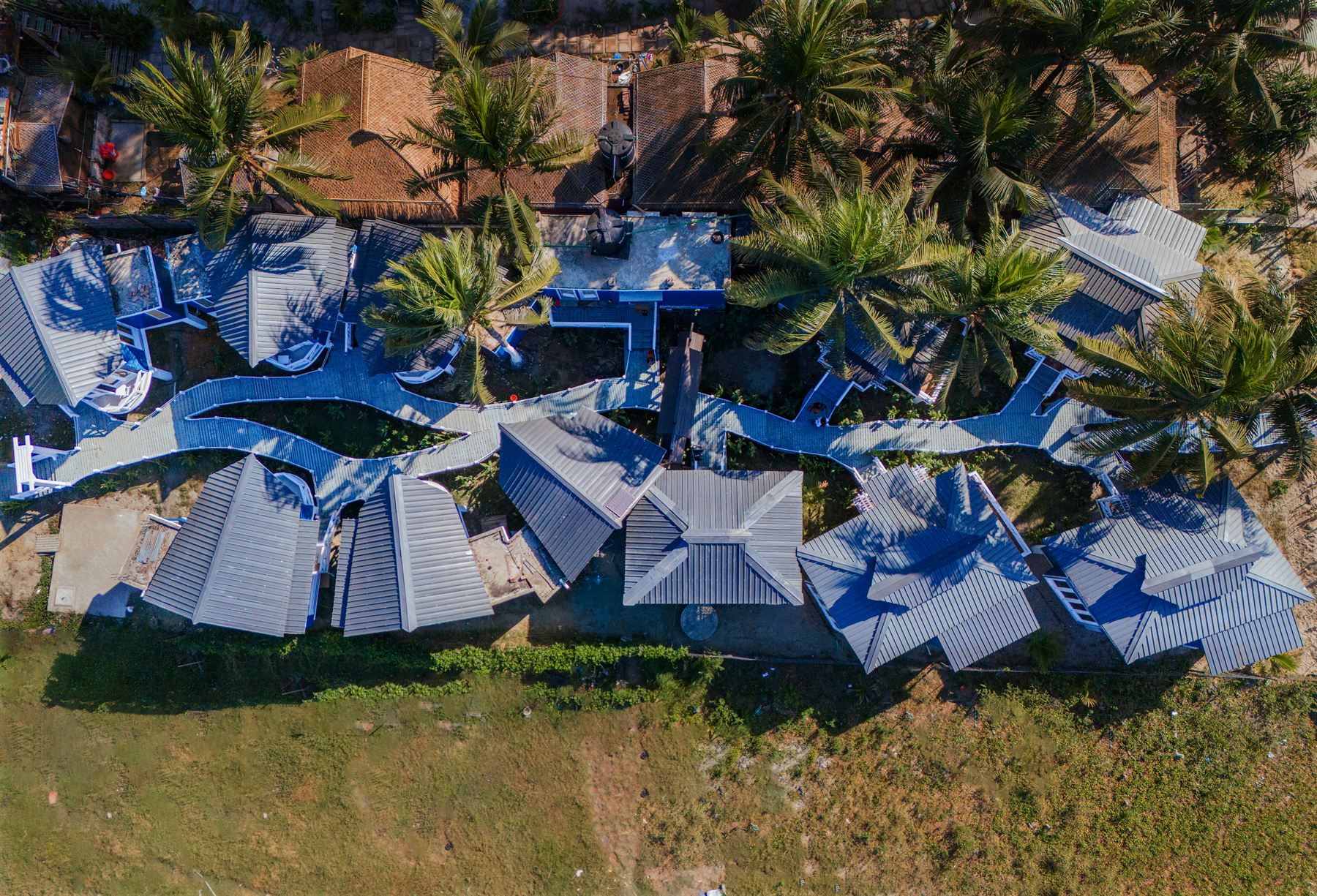 Sun & Sand cottages woven between the island palms